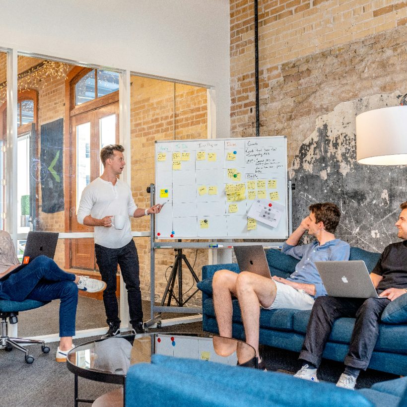 A delivery manager walking a team through a board of work in progress