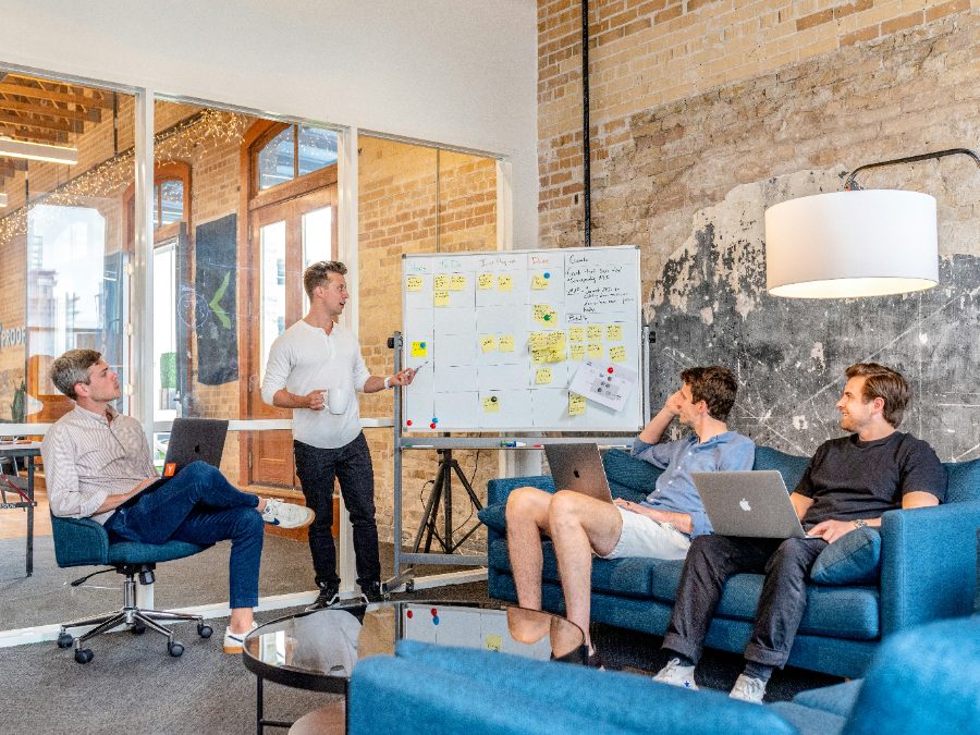 A team mapping a workflow together at a whiteboard